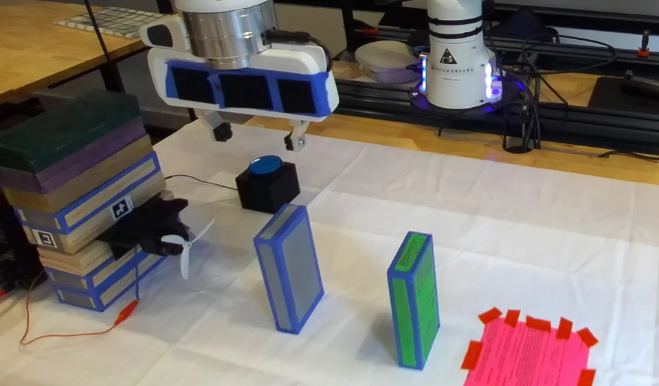 The robot has placed the gray block upwind of the green one.